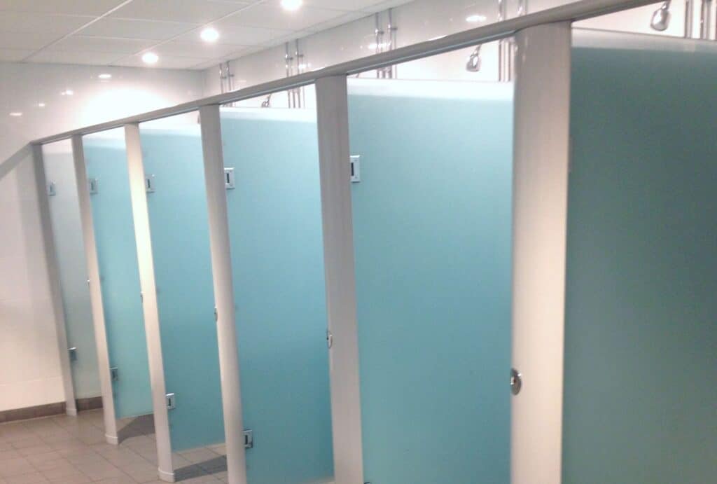 Curve Glass Shower Cubicles in a gym washroom