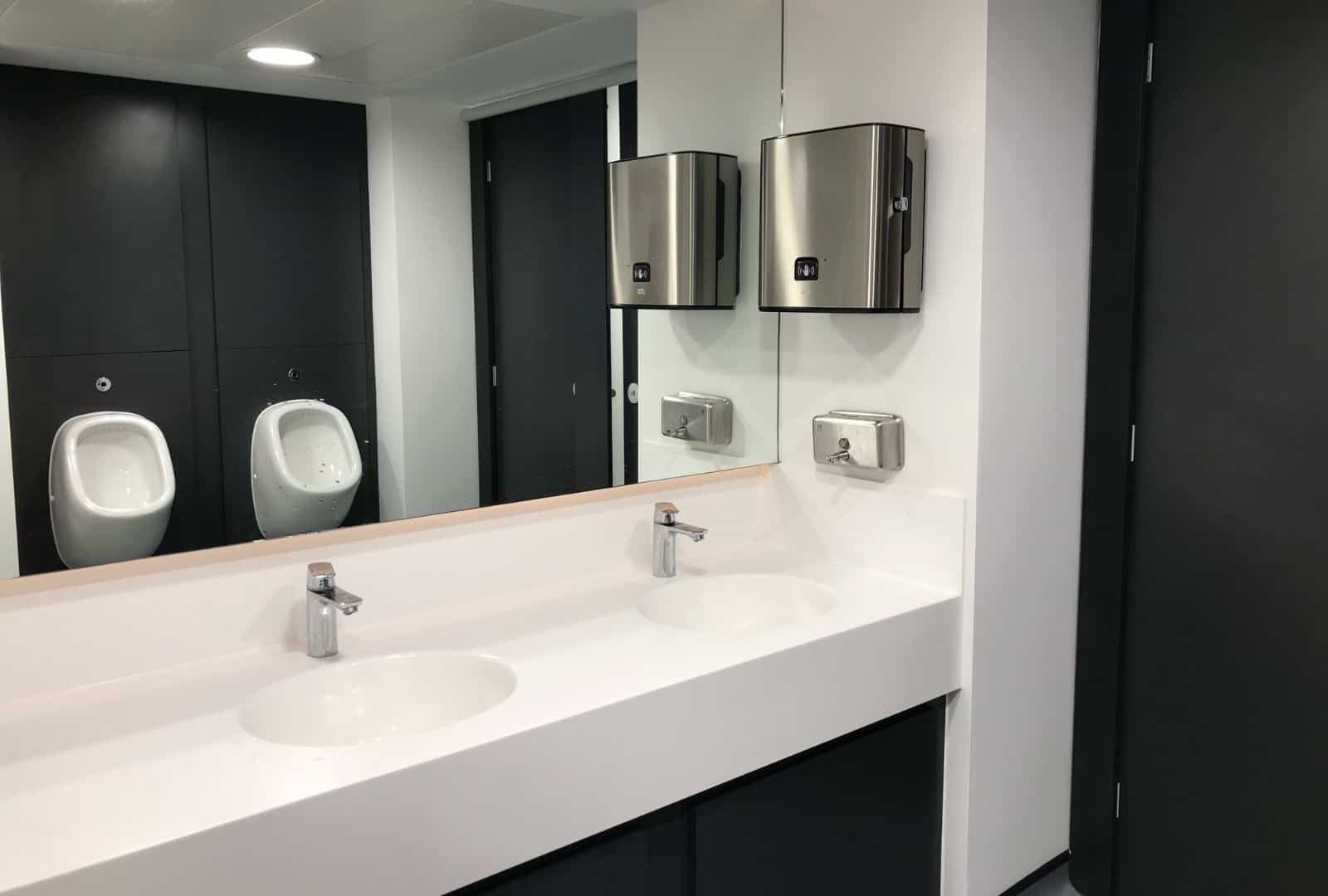 Solid surface vanities inside a washroom.