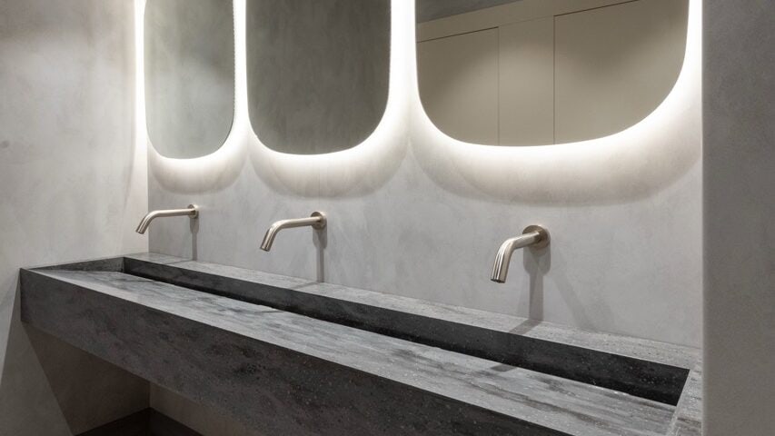 Cantilevered Solid Surface Wash Trough in a commercial washroom by Concept Washroom