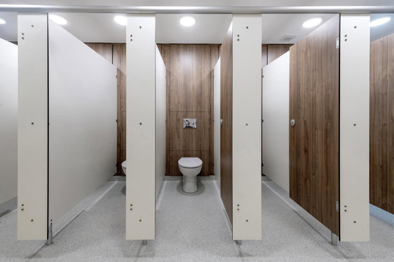 row of Force cubicles with compact grade laminate duct panels by Concept Washroom