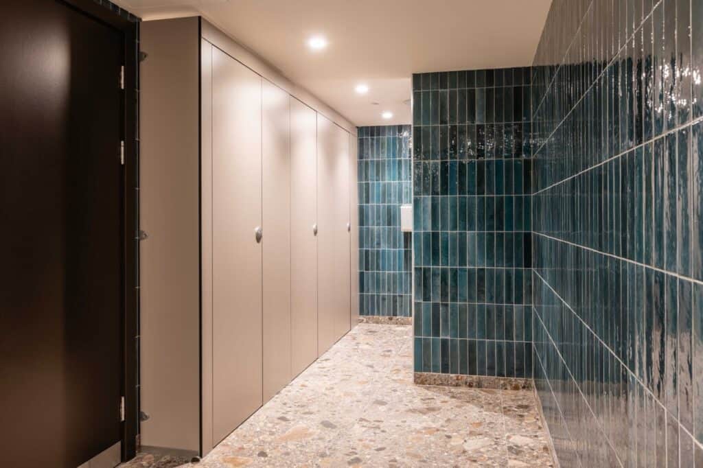 Clean modern washroom with blue tiled walls at London Bridge studio.