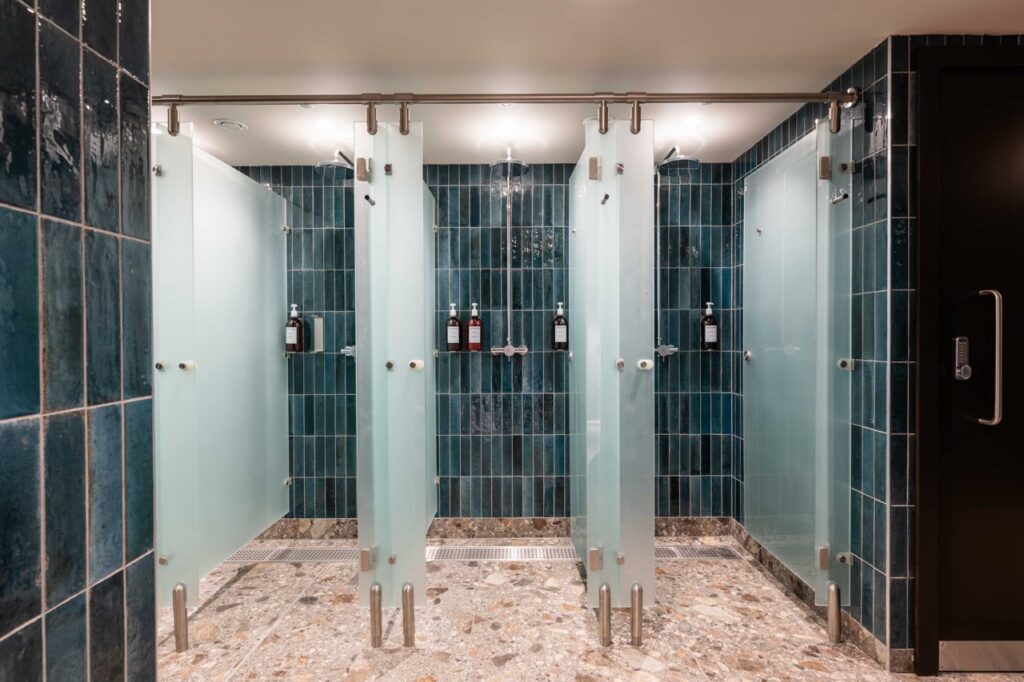 Clean, private washroom stalls with frosted glass doors at London Bridge studio.