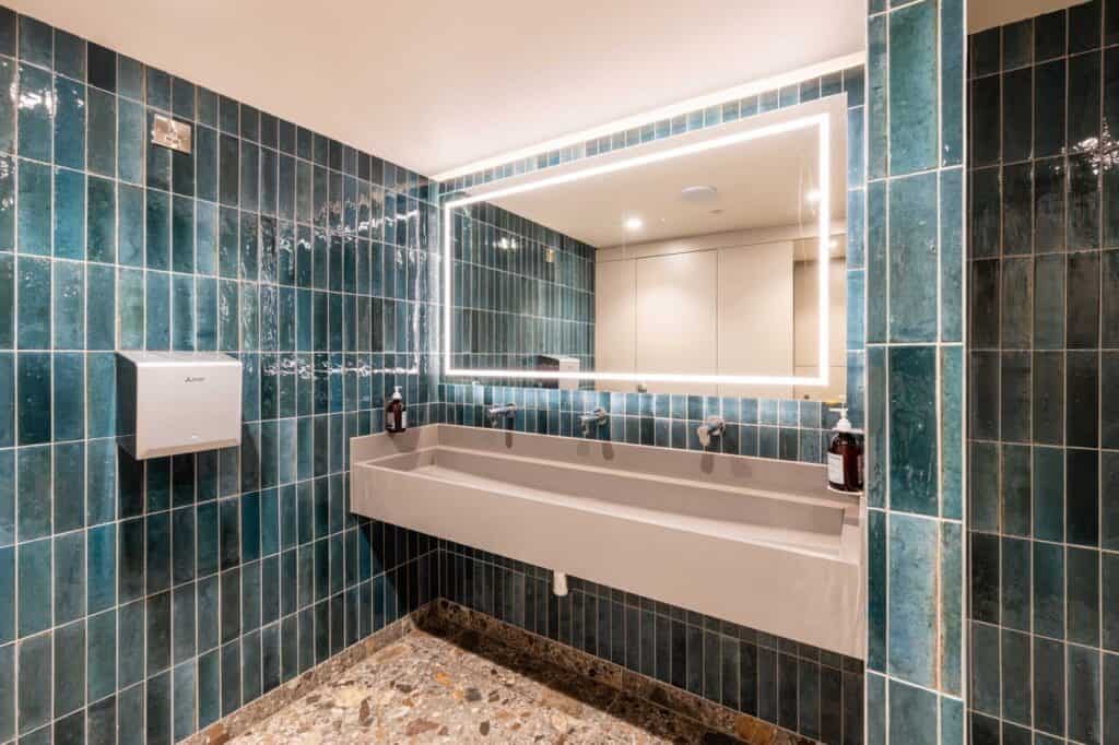 Solid surface wash trough in gym washroom area