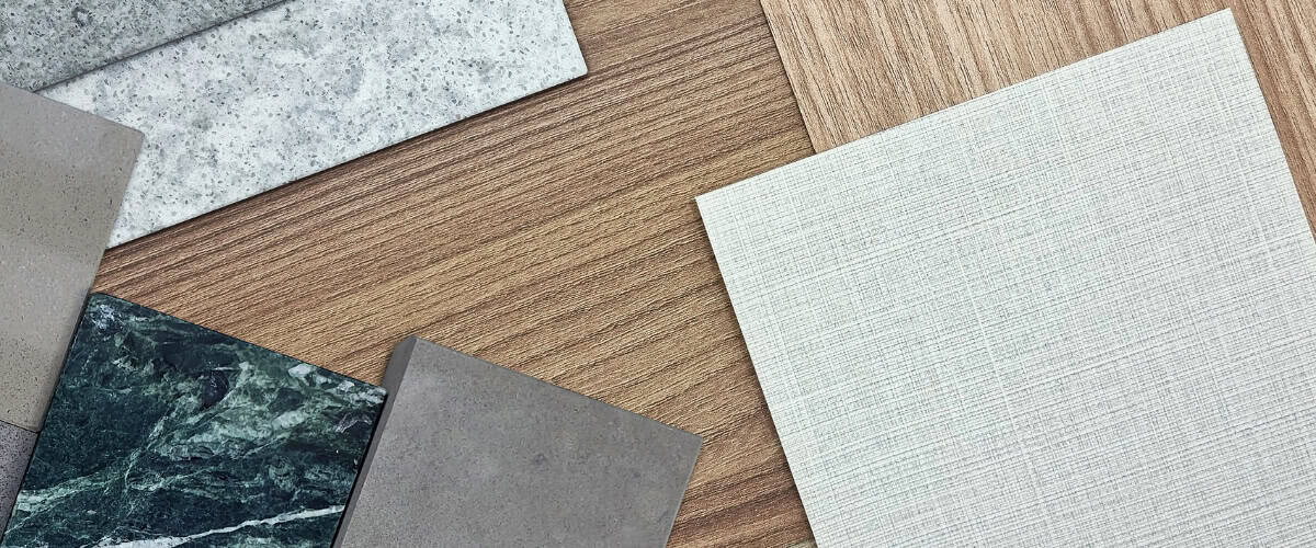 Assorted tile samples including marble, concrete, and textured tiles for washroom renovation project.