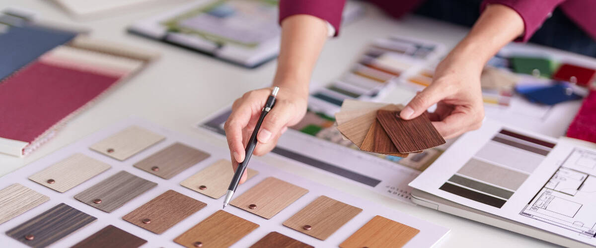 Interior designer choosing wood textures for washroom decor and fixtures.