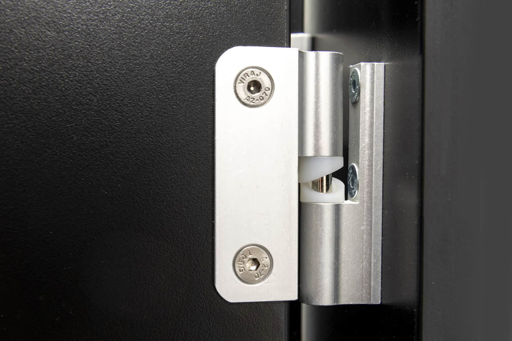Hinge mechanism on a washroom door, close-up view.