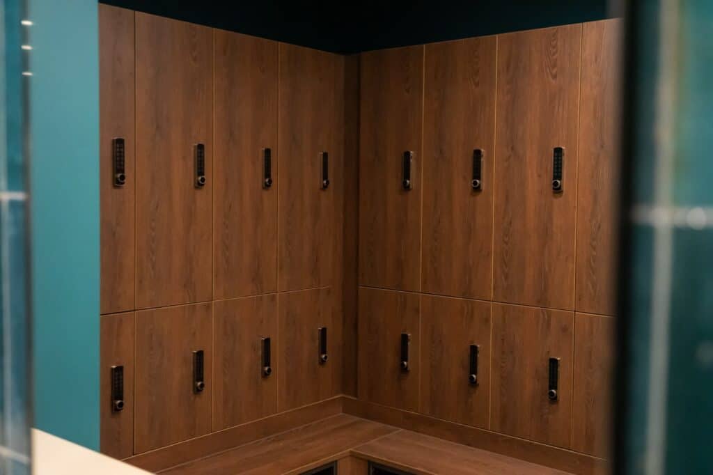 Wooden lockers with black handles in a modern facility.